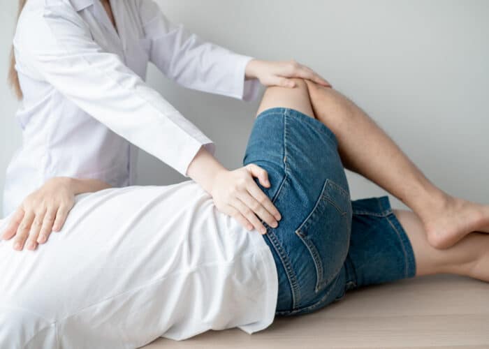 Patient receiving treatment for lower back & hip pain